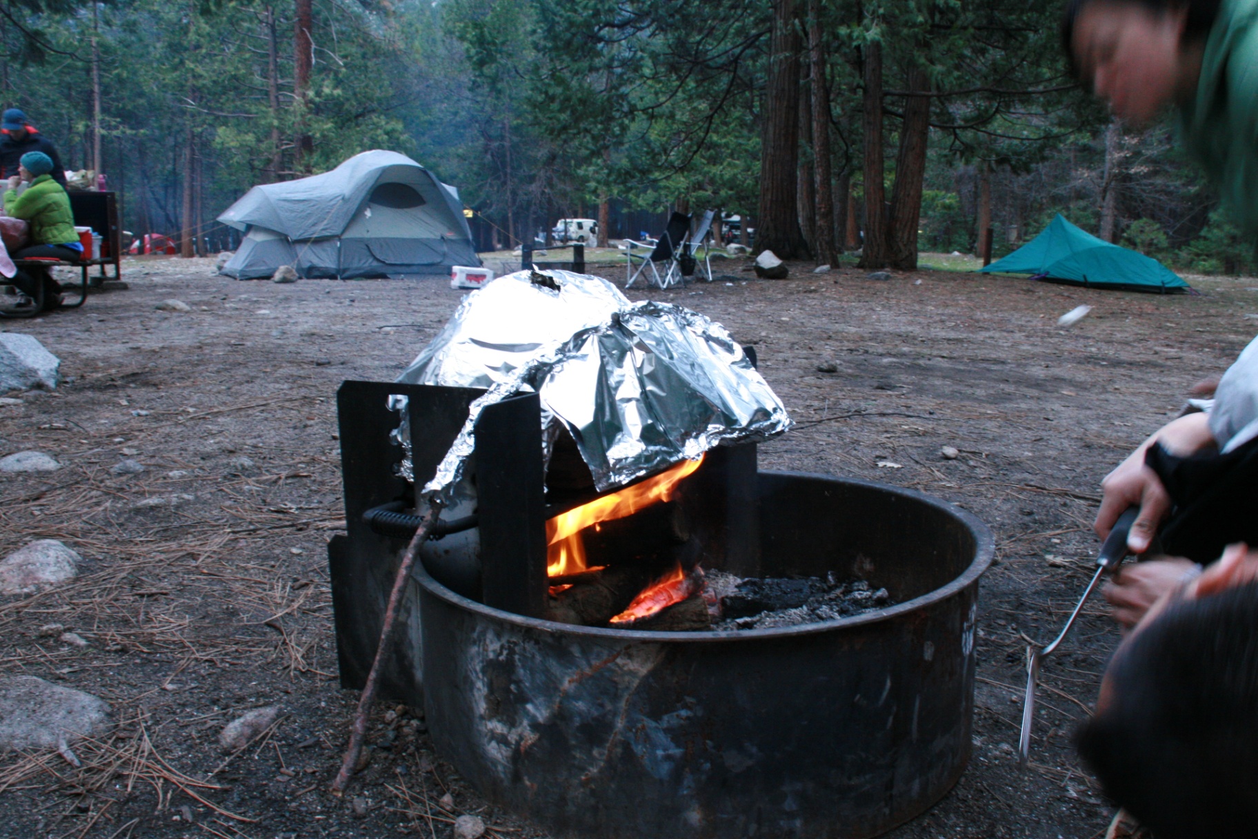 Full campsite view — note the foil door that kept heat trapped inside for even baking without rotating