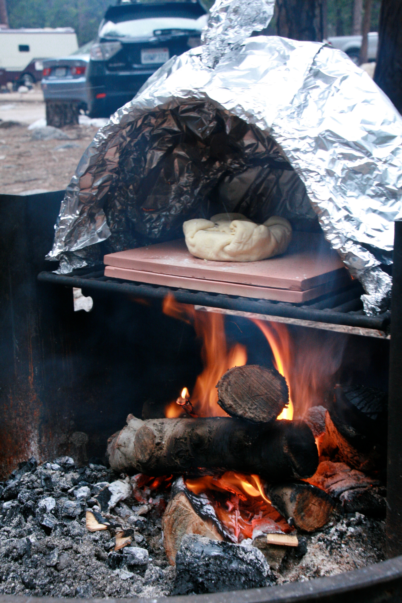 Beginning of the bake — raw dough on the pizza stone before the oven works its magic